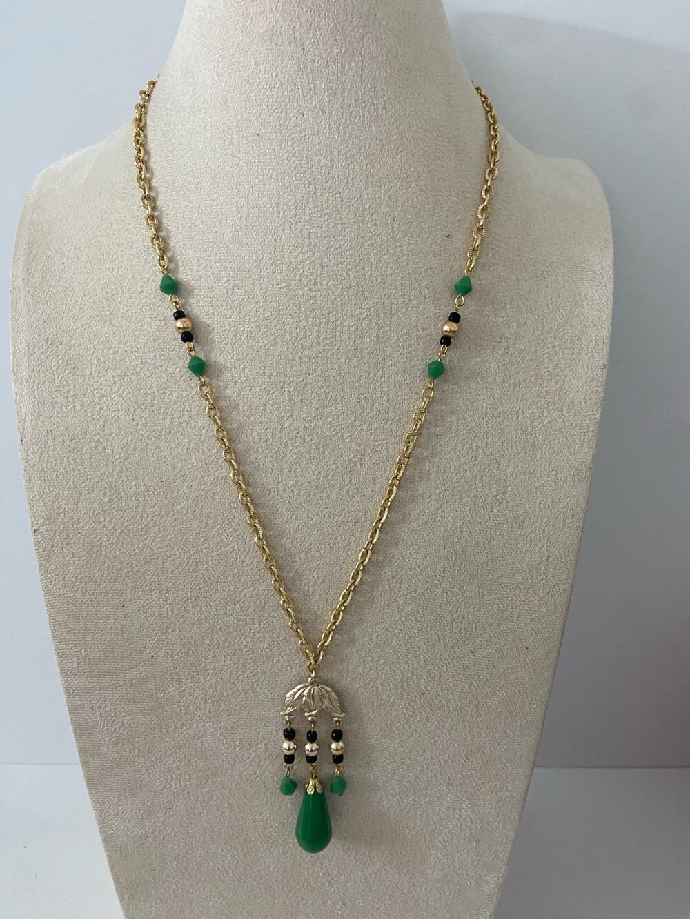 Gold tone and green tribal pendant necklace